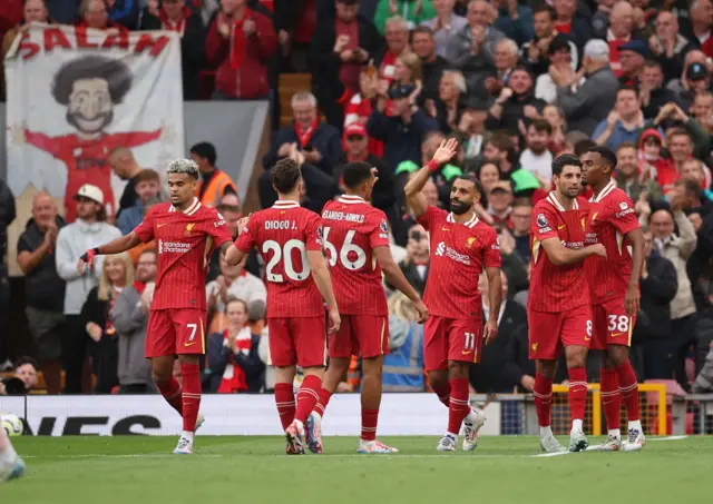 Liverpool players celebrate with Salah after his goal