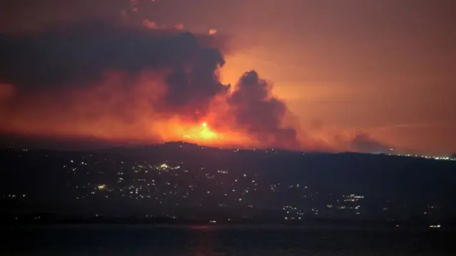 A view shows smoke and fire on the Lebanese side of the border with Israel, after Israel said it had noted armed group Hezbollah preparing to attack Israel and had carried out pre-emptive strikes on Hezbollah targets in Lebanon, as seen from Tyre, southern Lebanon August 25, 2024.