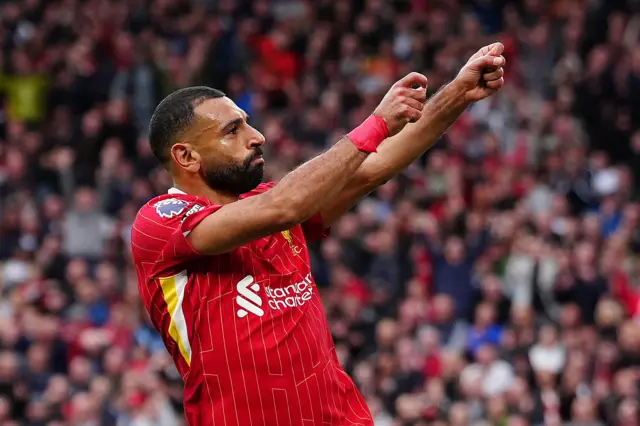 Salah does his new archer celebration after his goal