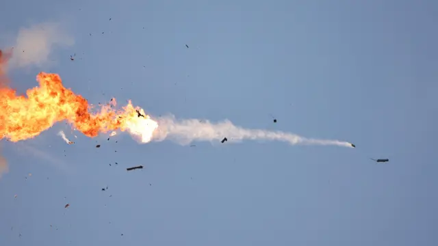 Fire in the sky as an unmanned aerial vehicle (UAV) is intercepted by an Israeli fighter jet.