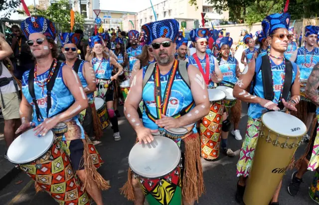 Drummers wearing blue shirts at the Notting Hill Carnival