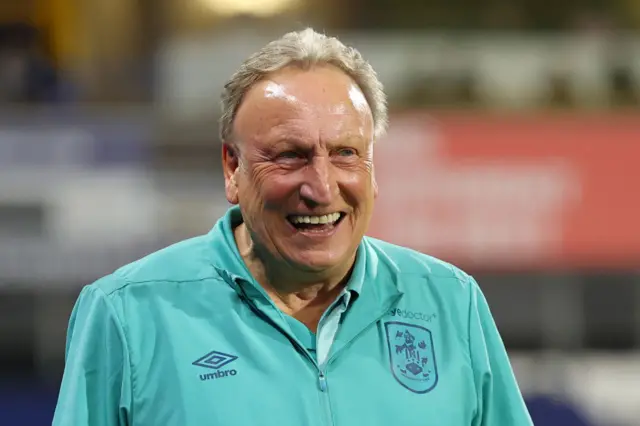 Neil Warnock smiling in Huddersfield kit