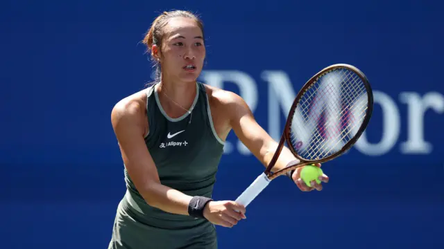 Zheng Qinwen prepares to serve at the US Open