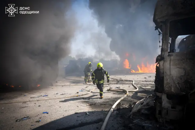 Firefighters work at the site of a Russian missile strike