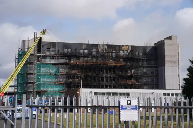 Fire crews continue to battle the fire at a building on Freshwater Road in Dagenham as large section of the building is visibly fire damaged