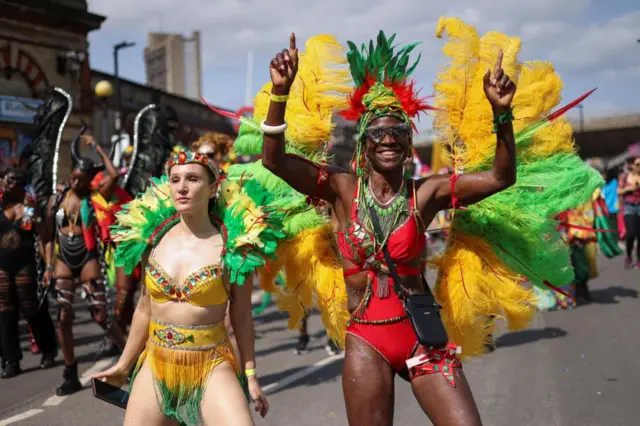 A woman dressed in a yellow costume next to a man dressed in a red one.