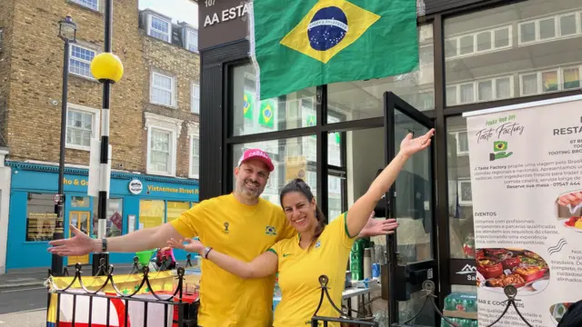 Rafael and Karina pose outside their food shop