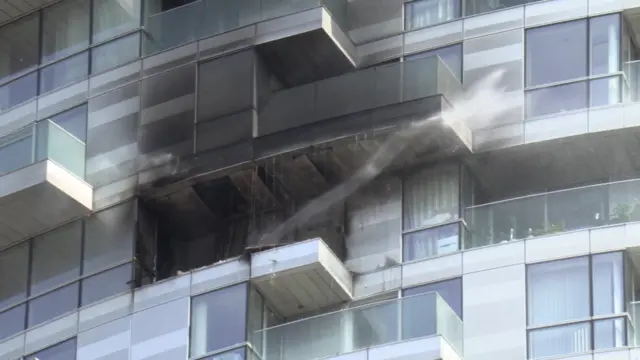 Blackened windows and balcony in tower block