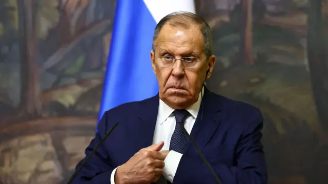 Russian foreign minister Sergei Lavrov with his hand in his jacket pocket