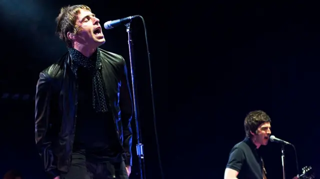 Liam and Noel Gallagher on stage