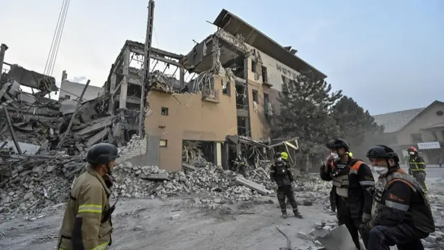 Rescuers stand at a site of a Russian missile strike, amid Russia's attack on Ukraine, in Kryvyi Rih, Ukraine August 27, 2024.