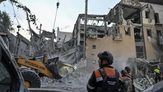 Rescuers work at a site of a Russian missile strike, amid Russia's attack on Ukraine,