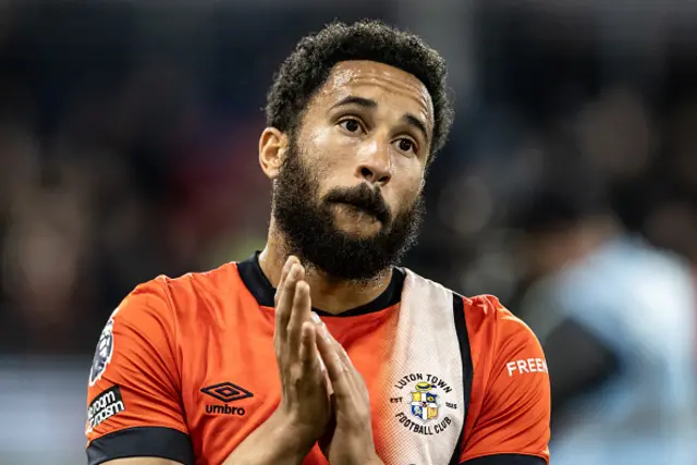 Andros Townsend applauds the fans while playing for Luton