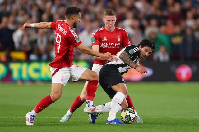 Sandro Tonali of Newcastle United tangles with Elliot Anderson and Alex Moreno