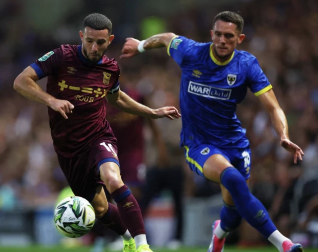 James Ball in action with Ipswich Town's Conor Chaplinr