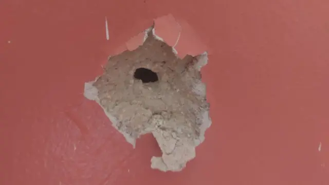 The PRCS shared this image of what looks like a bullet hole in a wall (close up shot)