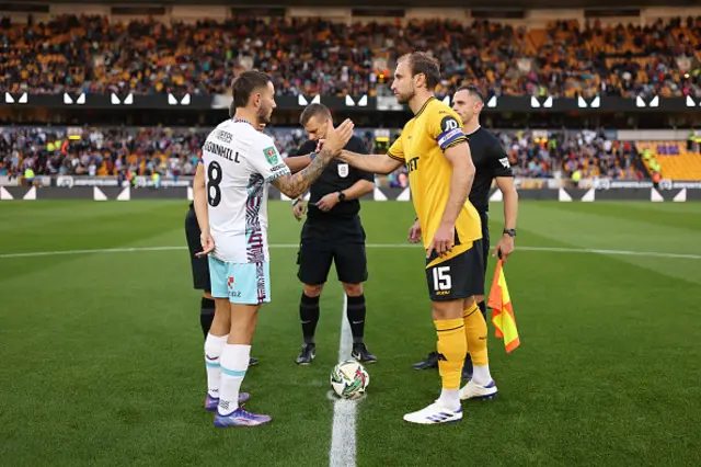 Josh Brownhill of Burnley shakes hands with Craig Dawson