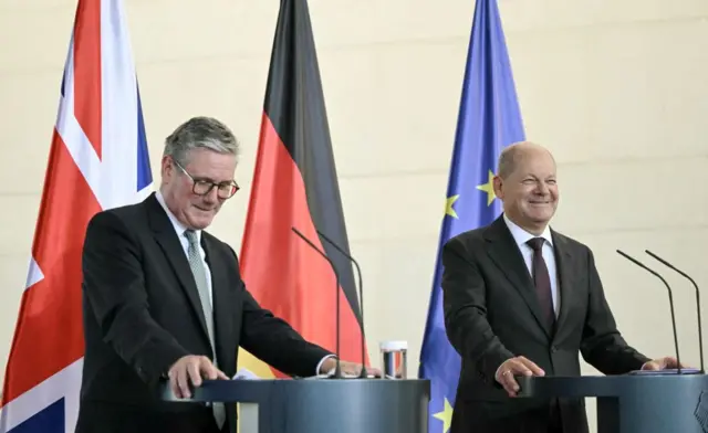 German Chancellor Olaf Scholz (R) and Britain's Prime Minister Keir Starmer attend a joint press conference after bilateral talks at the Chancellery in Berlin