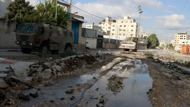 An Israeli military bulldozer drives down a road during a raid in northern city of Tulkarm in the occupied West Bank on August 28, 2024.