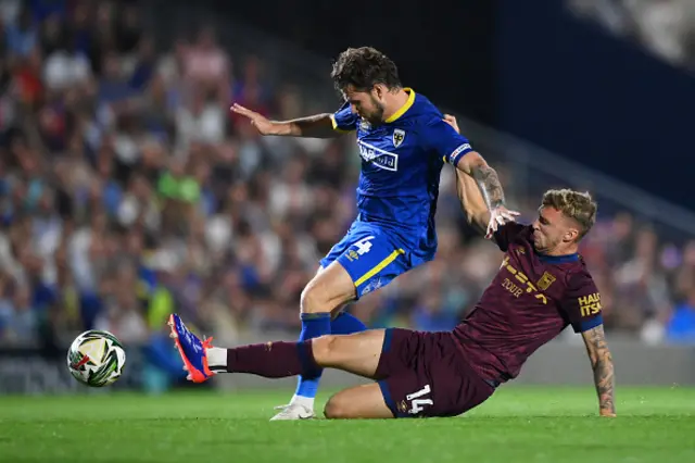 Jack Taylor of Ipswich Town clears the ball from Jake Reeves