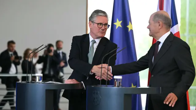 Prime Minister Keir Starmer and German Chancellor Olaf Scholz shake hands at the end of a joint press conference at the Chancellery in Berlin, during his visit to Germany and France.