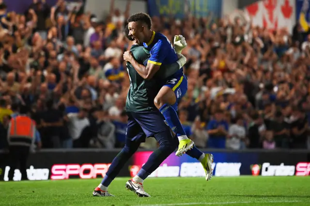 Isaac Ogundere of AFC Wimbledon celebrates with teammate Owen Goodman