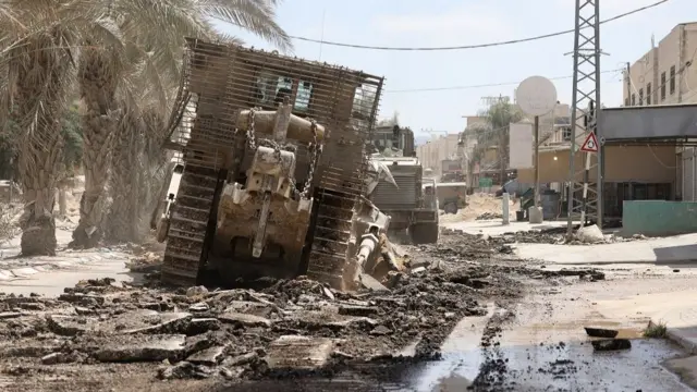 An Israeli military bulldozer destroys a road during a raid in the Nur Shams camp for Palestinian refugees near the city of Tulkarem in the Israeli-occupied West Bank on August 28, 2024