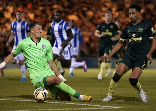 Colchester United goalkeeper Matthew Ryan Macey (left) saves a shot from Southampton's Joe Aribo