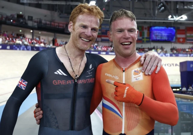 Tristan Bangma of Netherlands and Stephen Bate of Great Britain embrace