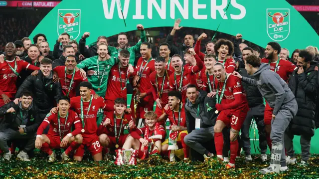 Liverpool players celebrate with the Carabao Cup after winning the 2024 final