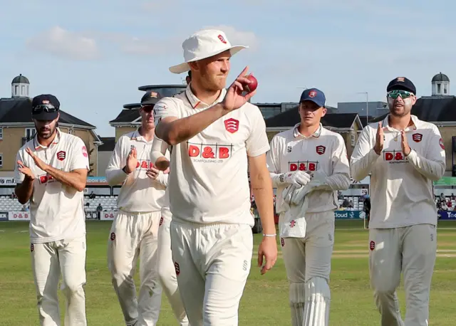 Jamie Porter walks off with the match ball after taking five wickets