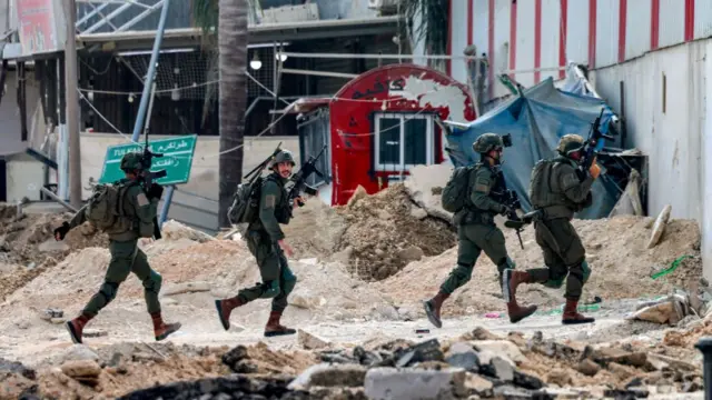 Four armed men in uniform