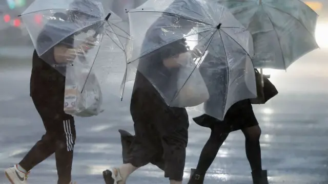 - Pedestrians battling the wind and rain in Kagoshima, southwestern Japan- Japan August 28, 2024, in this photo taken by Kyodo.