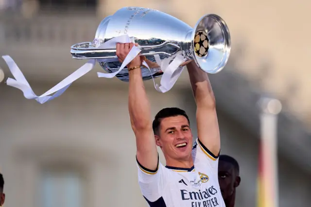 Kepa Arrizabalaga lifts the Champions League trophy, which he won as part of the Real Madrid squad last season