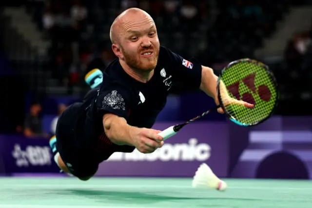 Krysten Coombs of Great Britain or Paralympics GB team competes against Chu Man Kai of Hong Kong during their Para Badminton Men's Singles SH6 Group Play Stage - Group A match