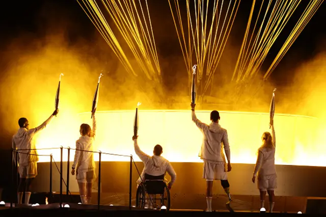 France's paralympic torchbearers, Charles-Antoine Kaoukou, Nantenin Keita, Fabien Lamirault, Alexis Hanquinquant and Elodie Lorandi hold the Paralympic flame in front of the Paralympic cauldron