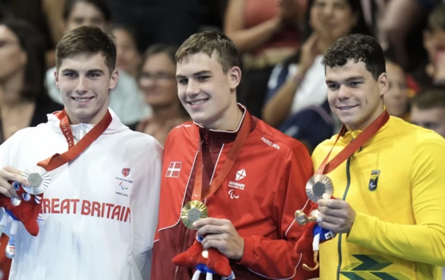 Alexander Hillhouse (centre) celebrates with the gold medal, alongside second place Great Britain's William Ellard (left) with silver and third place Brazil's Gabriel Bandeira with bronze