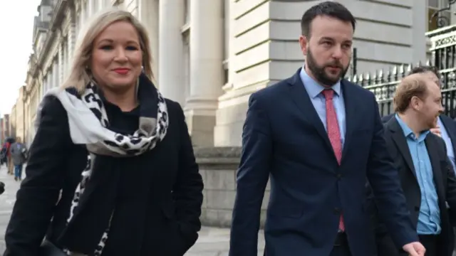 Michelle O'Neill walking along side Colum Easwood