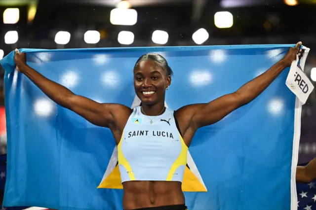 St Lucia's Julien Alfred celebrates after winning the women's 100m final