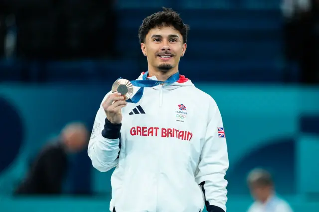 Bronze medalist Jake Jarman of Great Britain poses with his medal