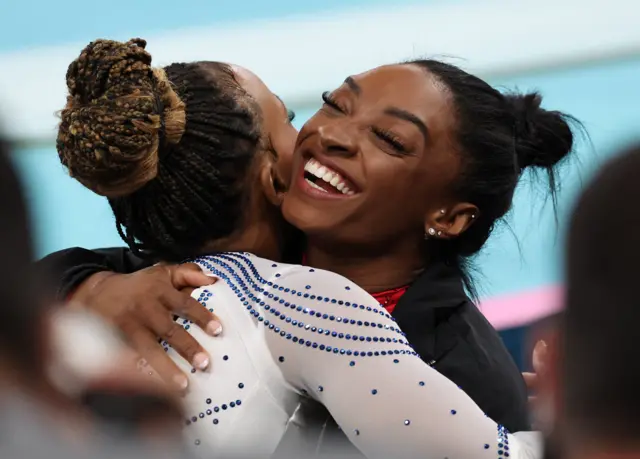 Biles and Andrade embrace after the standings are finalised