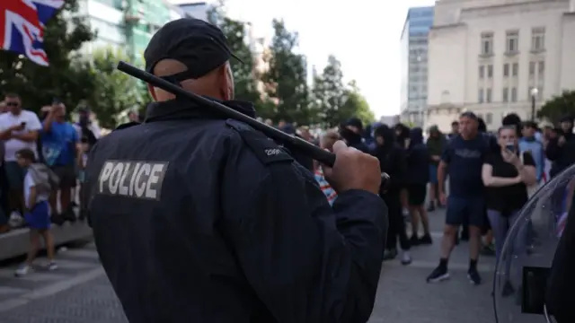 riot police with a baton