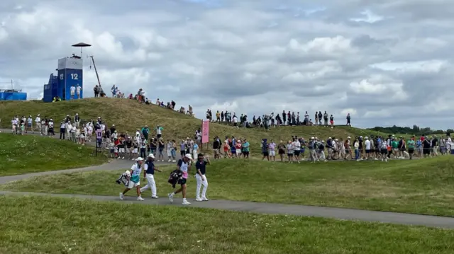 Tommy Fleetwood waves to fans at the Paris 2024 Olympics