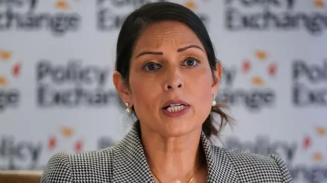 Former Home Secretary Dame Priti Patel speaking at an event, gesturing with her hand