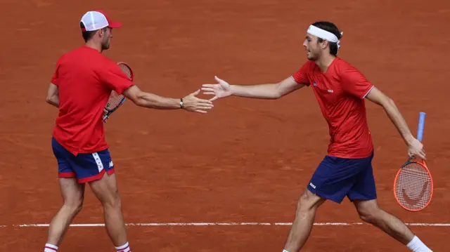 Taylor Fritz and Tommy Paul celebrate winning a point