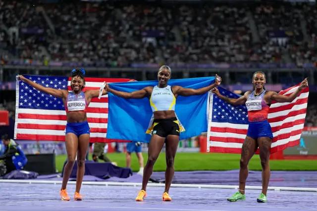 Gold medal winner Julien Alfred of Saint Lucia (C), silver medal winner Sha'Carri Richardson of United States (R) and bronze medal winner Melissa Jefferson of United States (L)