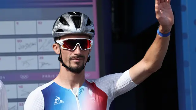 Julian Alaphilippe waves to the crowd before the men's road race at the Paris 2024 Olympics