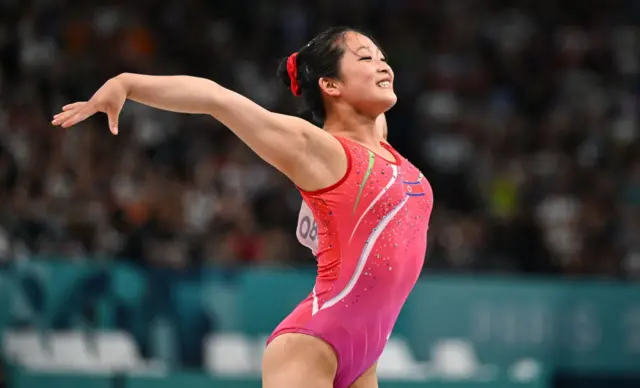 An Chang-ok smiles after landing a vault at the Paris Olympics