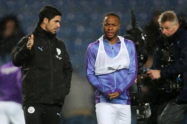 Mikel Arteta assistant coach of Manchester City speaks to Raheem Sterling