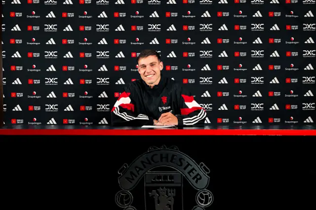 Manuel Ugarte of Manchester United poses after signing for the club